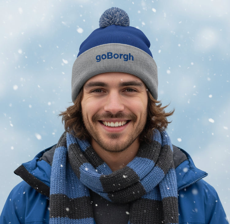 Model wearing a goBorgh® pom-pom knit beanie from the goBorgh® Crowns collection, premium winter headwear.