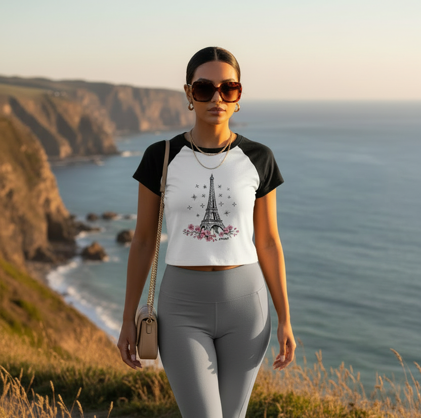 Elevated sporty look featuring the  Paris in Bloom, Eiffel Tower cherry blossom cropped baby tee styled with neutral activewear during a scenic coastal walk.