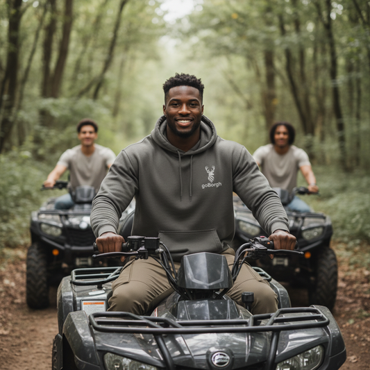 Group riding ATVs wearing the goBorgh® Highland Frontier™ Stag premium hoodie in Pigment Black outdoors