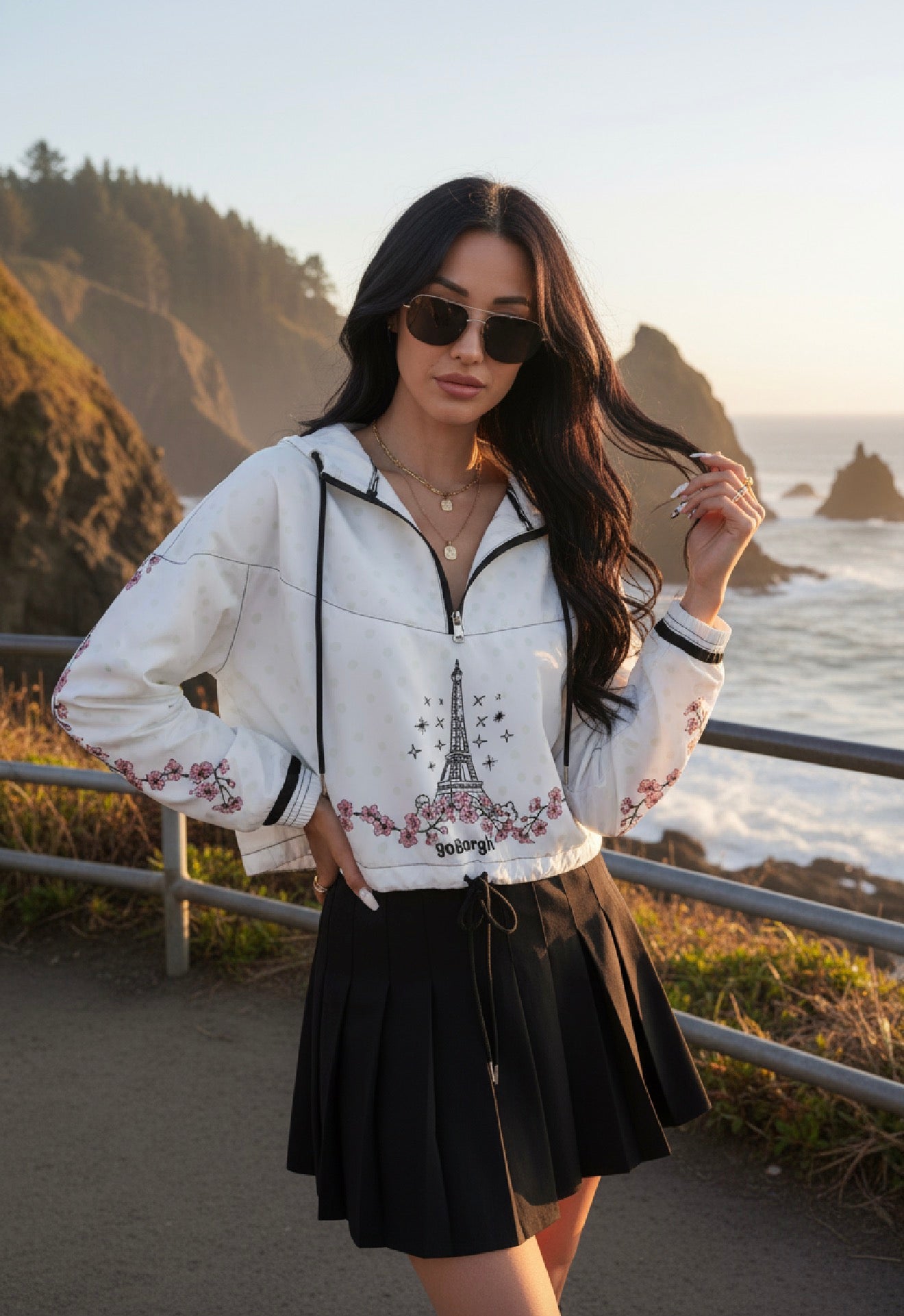 Front view of model wearing goBorgh Paris in Bloom cherry blossom half zip windbreaker featuring Eiffel Tower artwork and floral detailing.