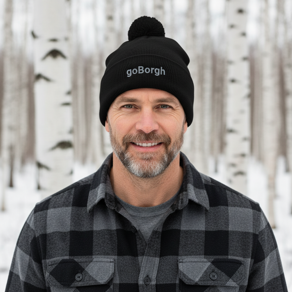 Man wearing a black goBorgh knit beanie in a snowy forest environment