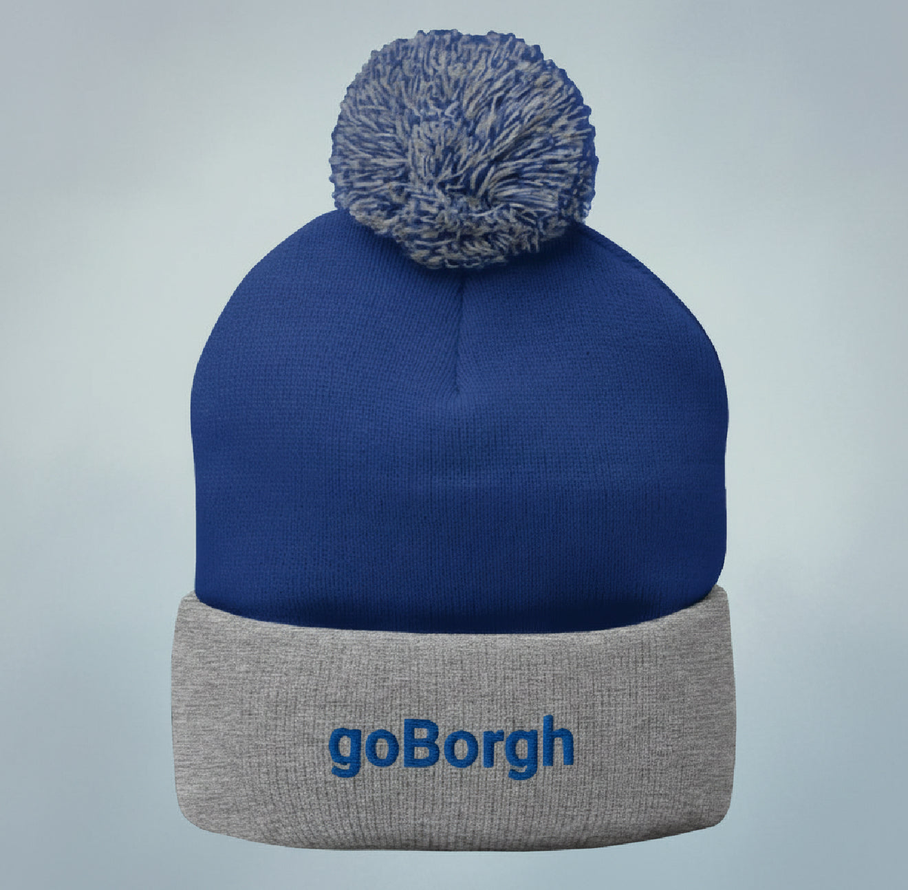 Blue goBorgh knit beanie with pom shown flat, logo visible on cuff