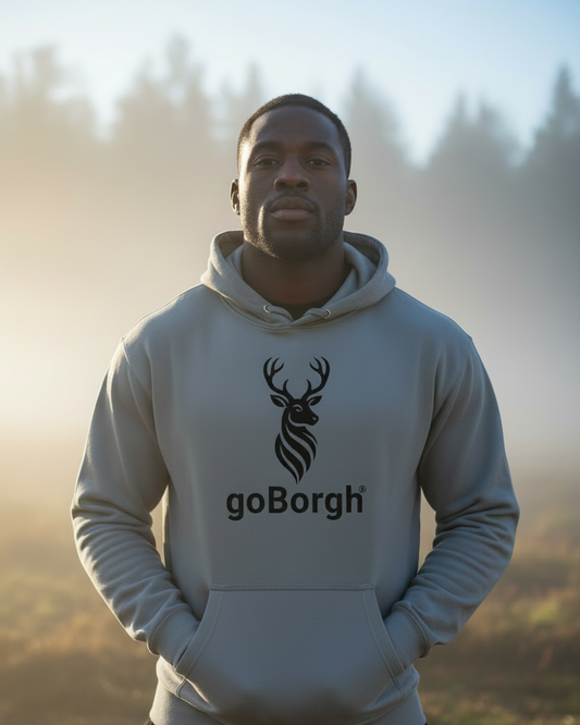 Model wearing the goBorgh® Highland Frontier hoodie in Storm Blue, shown outdoors with a rugged, natural setting
