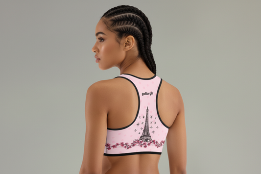 Side and back angle of the goBorgh Paris in Bloom Eiffel Tower Cherry Blossom sports bra showing racerback silhouette and cherry blossom band in pale pink
