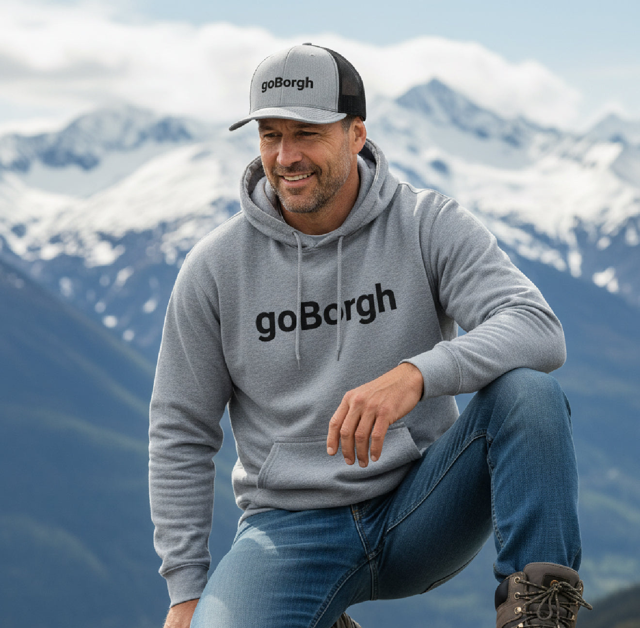 man wearing goBorgh snapback trucker cap outdoors in mountains