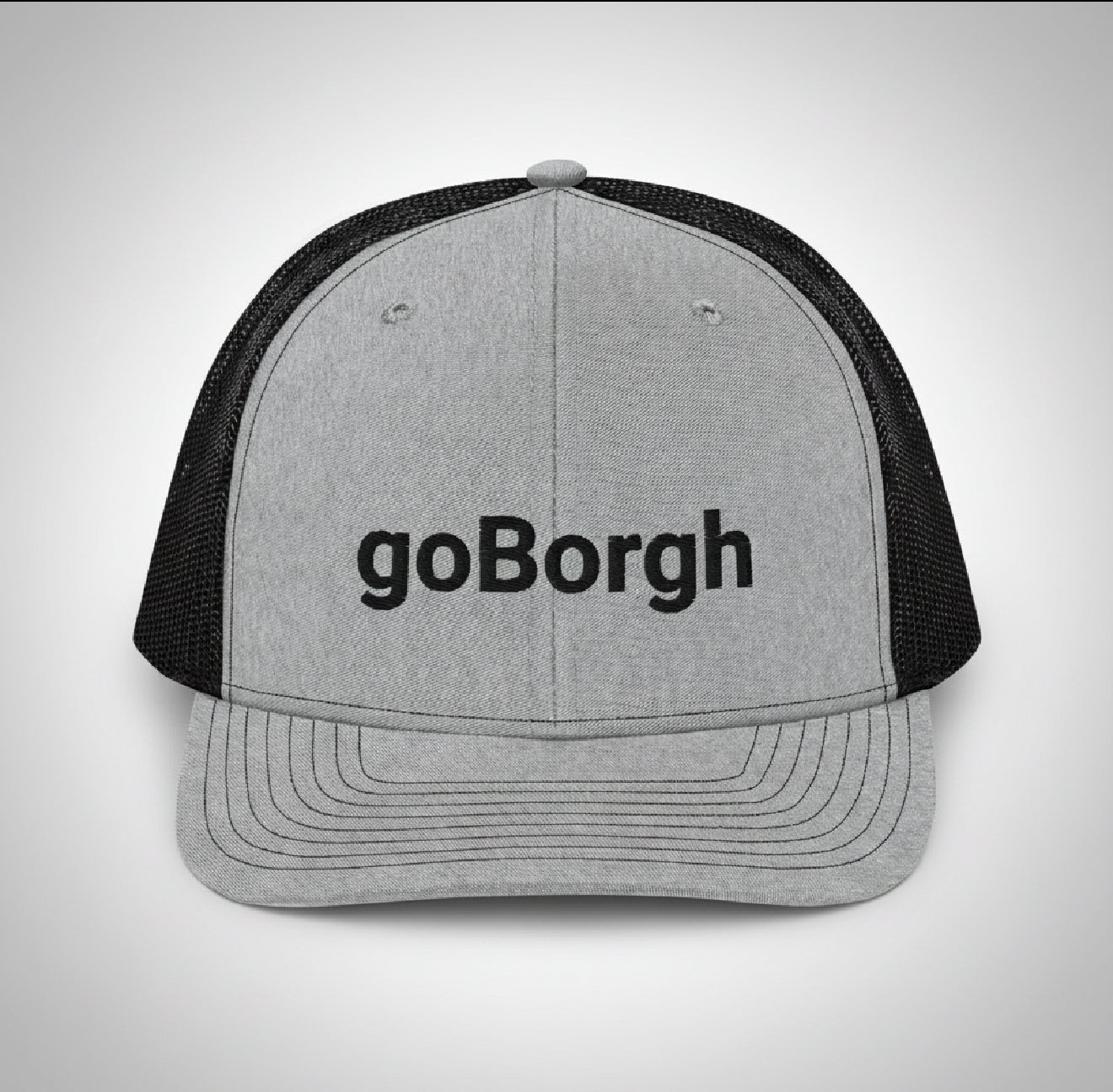 close up of goBorgh snapback trucker cap showing mesh back and curved bill